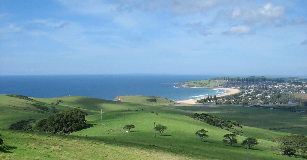 The lush green hills of farmland overlooking the ocean and the beaches of NSW South Coast, Australia
